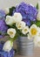 Posy of white tulips and blue hortensia flowers