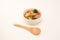 pot-au-feu vegetables sausage soup isolated wood spoon on white background