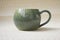 Pot-bellied mug made of clay with a spectacular aqua glaze in the estuary. ceramics, handmade. reminder of the sea and travel