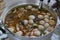 The pot is boiling curry paste, chicken feet with meatballs, Asian food, delicious Thai food with vegetables, herbs,