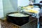 Pot with boiling oil to prepare the typical Polenta Gialla, boiled corn flour, traditional from Italy and countries of South