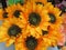 A pot bouquet of artificial fake yellow sunflowers on display