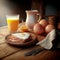 Pot of coffee, orange juice , becon and eggs, hearty morning breakfast