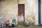 Pot for flowers, two chairs near abandoned grunge cracked wall