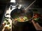 A pot full of vegetables cooking on a stove. AI generative image