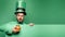 Pot of gold. Green patricks background. Man in Saint Patrick`s Day leprechaun party hat having fun on green background.