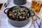 Pot of gourmet mussels garnished with fresh herbs