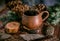 Pot of hot herbal tea, fir cones and paws of blue fir on wooden background