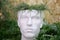 Pot for indoor plants in the shape of a head of man, that made of plaster