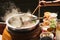 .The pot is prepared for cooking. The noodles are in low-light, boiling water with white smoke and steam on black background