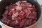 Pot of raw beef cubes washed for boiling