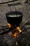 A pot of soup on fire in the forest