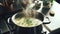 A Pot of Steaming Savory Homemade Bone Broth with Fresh Herbs