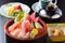 Pot of sushi with shrimp, tuna, salmon, fruit in Japanese style