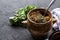 a pot with vats of greens and a towel on a dark background