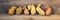 Potato banner, ugly potatoes on a wooden background. Potato variety, unique