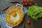 Potato casserole with bolognese. Baked potato casserole with egg and grated cheese in a ceramic oval baking sheet. Wooden dark