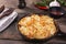 Potato casserole with cheese in a frying pan serving vegetarian dish homemade