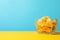 Potato chips. Beer snacks on yellow background against blue background