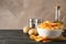 Potato chips in a bowl on craft paper. Potato, spice, olive oil on wooden background