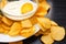 Potato chips and bowl of sour cream on a white plate. Fast food. Rustic food background