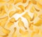 Potato chips in a chaotic position in the air on a yellow background