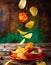 Potato chips falling down on an old rustic wooden table