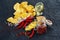 Potato chips and ingredients on a black paper background.