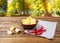 Potato chips, napkin, hot chili pepper on wooden table on blurred park background.Tablecloth, holiday