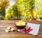 Potato chips, napkin,red pepper on wooden table on blurred park background.Tablecloth holiday concept