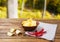 Potato chips, napkin,red pepper on wooden table on blurred park background.Tablecloth holiday concept