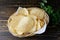 Potato chips (Potato crisps) on wooden table