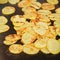 Potato chips seasoned with spices grilled on electric grill, closeup detail