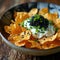 Potato chips with sour cream and black caviar.