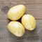 Potato close-up on wooden table