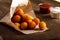 Potato croquettes with red and white sauce on wooden table