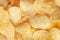 Potato fluted chips close-up. Background of corrugated chips top view