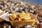 Potato fries in take out box on a sea sea beach