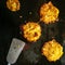 Potato fritters frying on a griddle