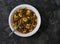 Potato gnocchi with classic bolognese sauce and spinach on a dark background, top view