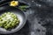 Potato gnocchi with pesto, parmesan cheese and spinach. Italian pasta. Black background. Top view. Copy space