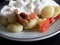 Potato gnochi with tomatoes, cream and cheese