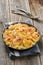 Potato gratin in casserole with cream and cheese