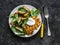 Potato latkes with baked apples, spinach salad on a dark background, top view. Delicious breakfast, snack, vegetarian lunch