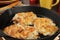 Potato latkes in a cast iron skillet