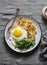 Potato latkes, fried egg and arugula - delicious healthy breakfast or snack. On a gray table