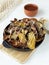 Potato nachos in a cast iron skillet. Crispy baked potato skins are rich in nutrients. Vegetable peels are one of the