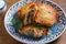 Potato Pancakes Filled With Meat. Vegetable fritters stuffed with meat. Latkes on blue plate.