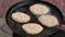 Potato pancakes, fried deep-fried in a pan over an open fire.