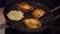 Potato pancakes are fried in a frying pan. Traditional potato dish. Vegetarian fried food